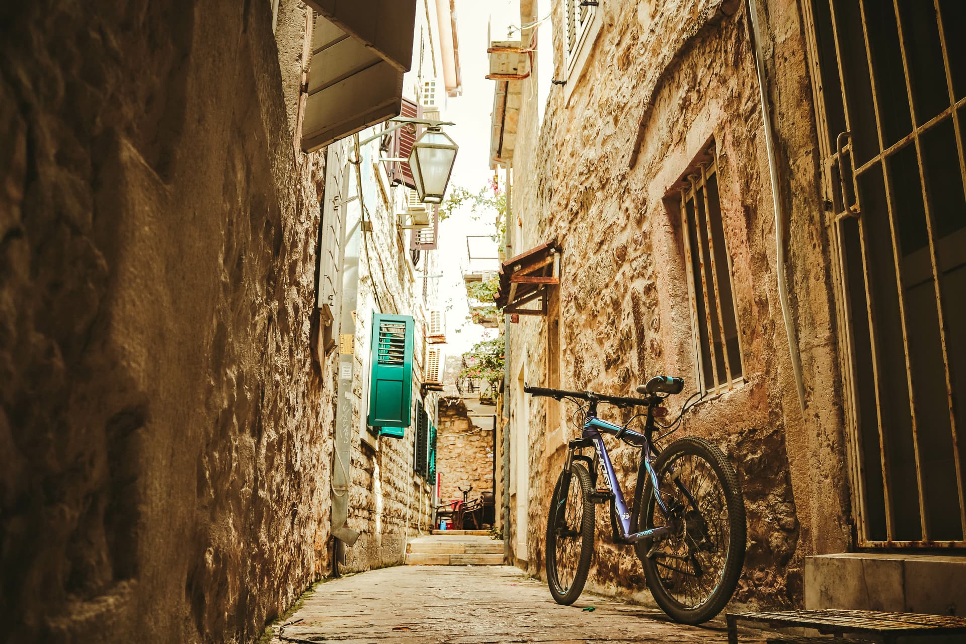 Bicycle parked on narrow cobblestone street in Budva, Montenegro old town.