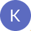 White letter K on blue circular background